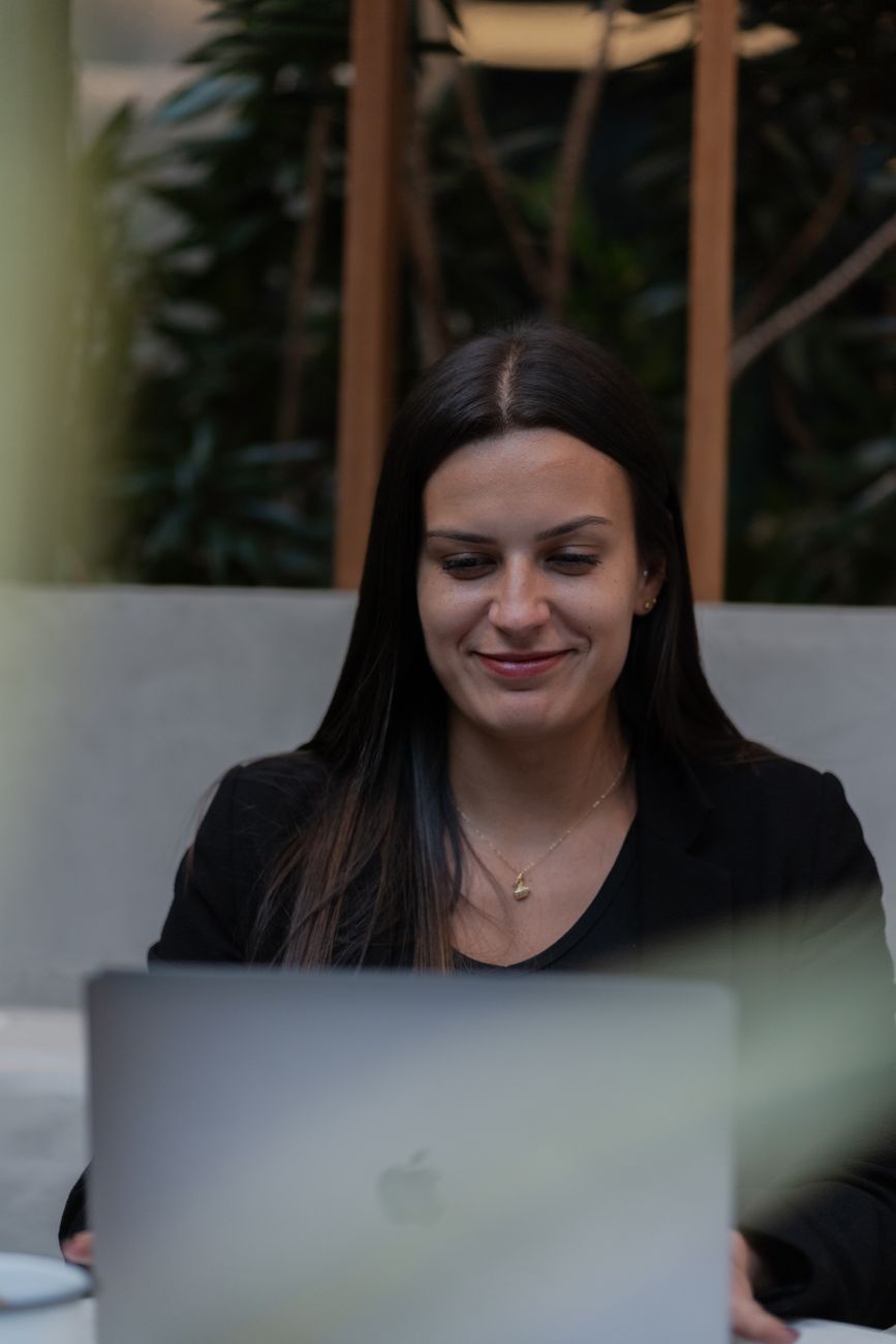 young professional woman using laptop indoors